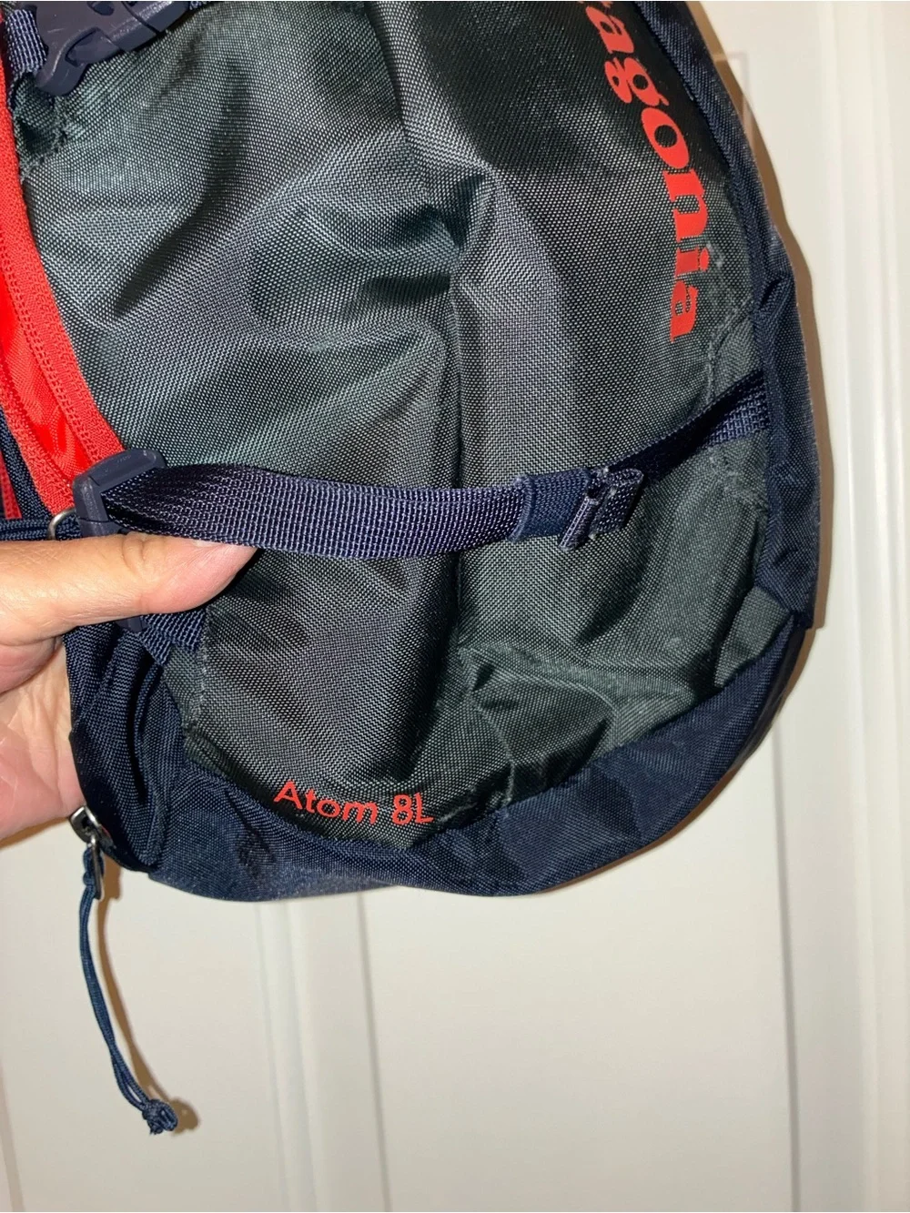 Patagonia Atom Sling 8L crossbody pack in a navy blue